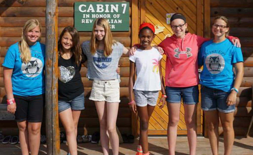 Girls outside of a cabin