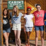 Girls outside of a cabin